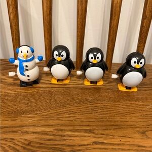 wind-up penguin toys, including one snowman variant.